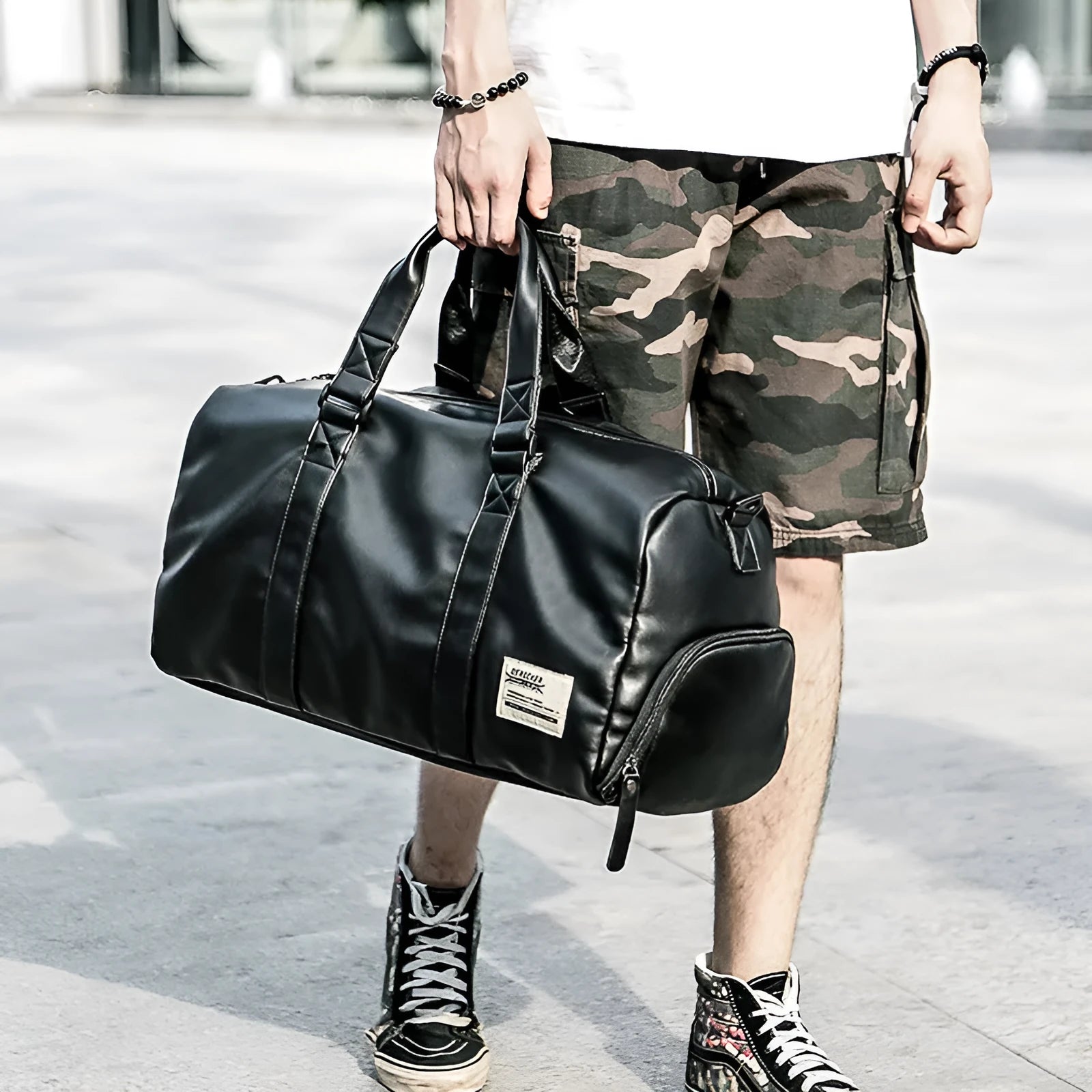 Black waterproof PU leather gym sports training bag showing internal laptop and camera compartments