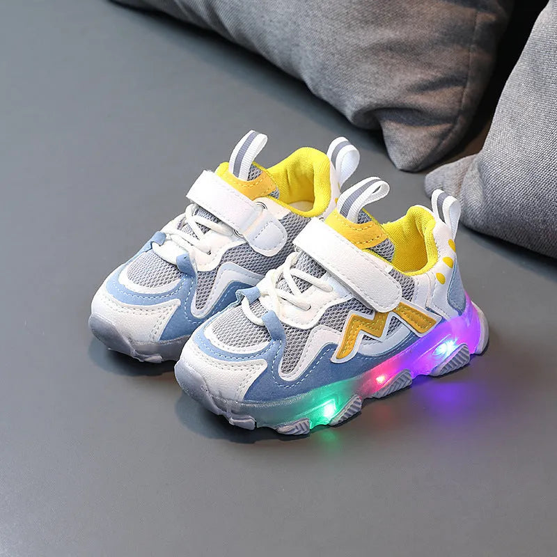 Kids black mesh sneakers with Velcro strap and rubber sole on a white background.
