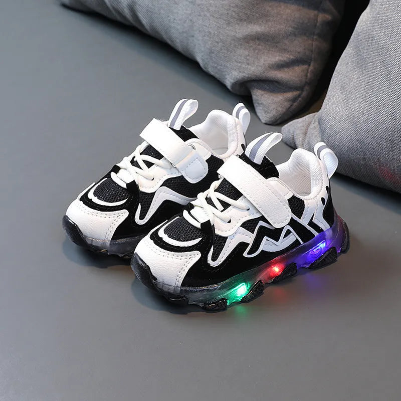 Kids black mesh sneakers with Velcro strap and rubber sole on a white background.