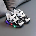 Kids black mesh sneakers with Velcro strap and rubber sole on a white background.