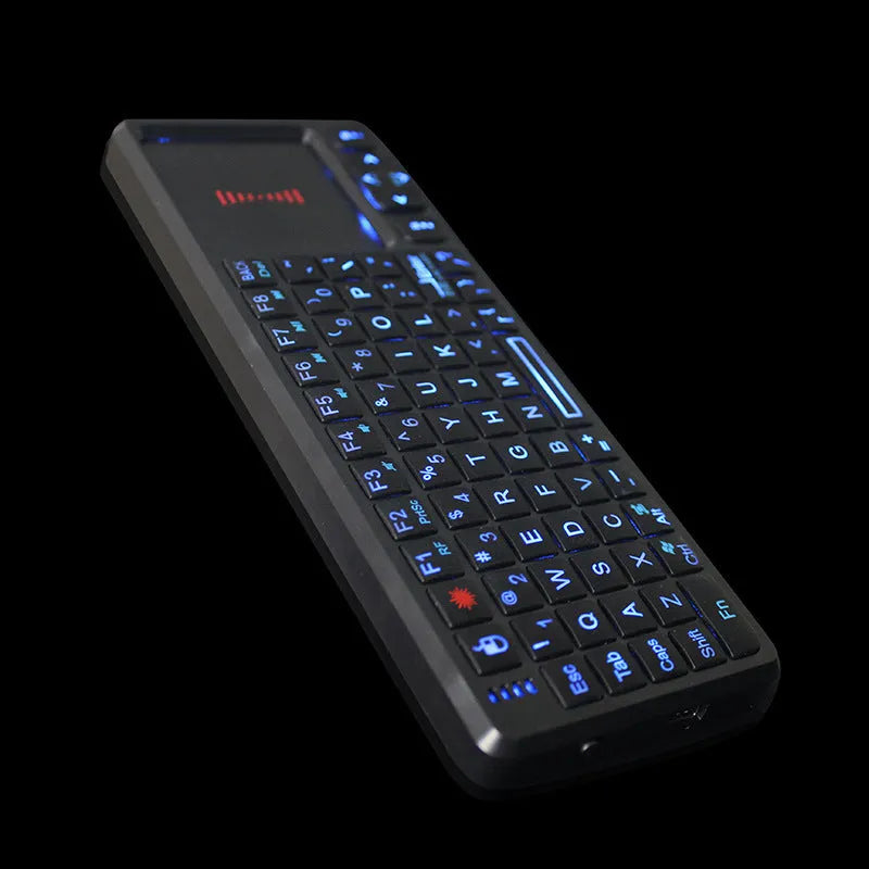 Black wireless laser teaching mini keyboard with touch screen and backlit keys on a desk.