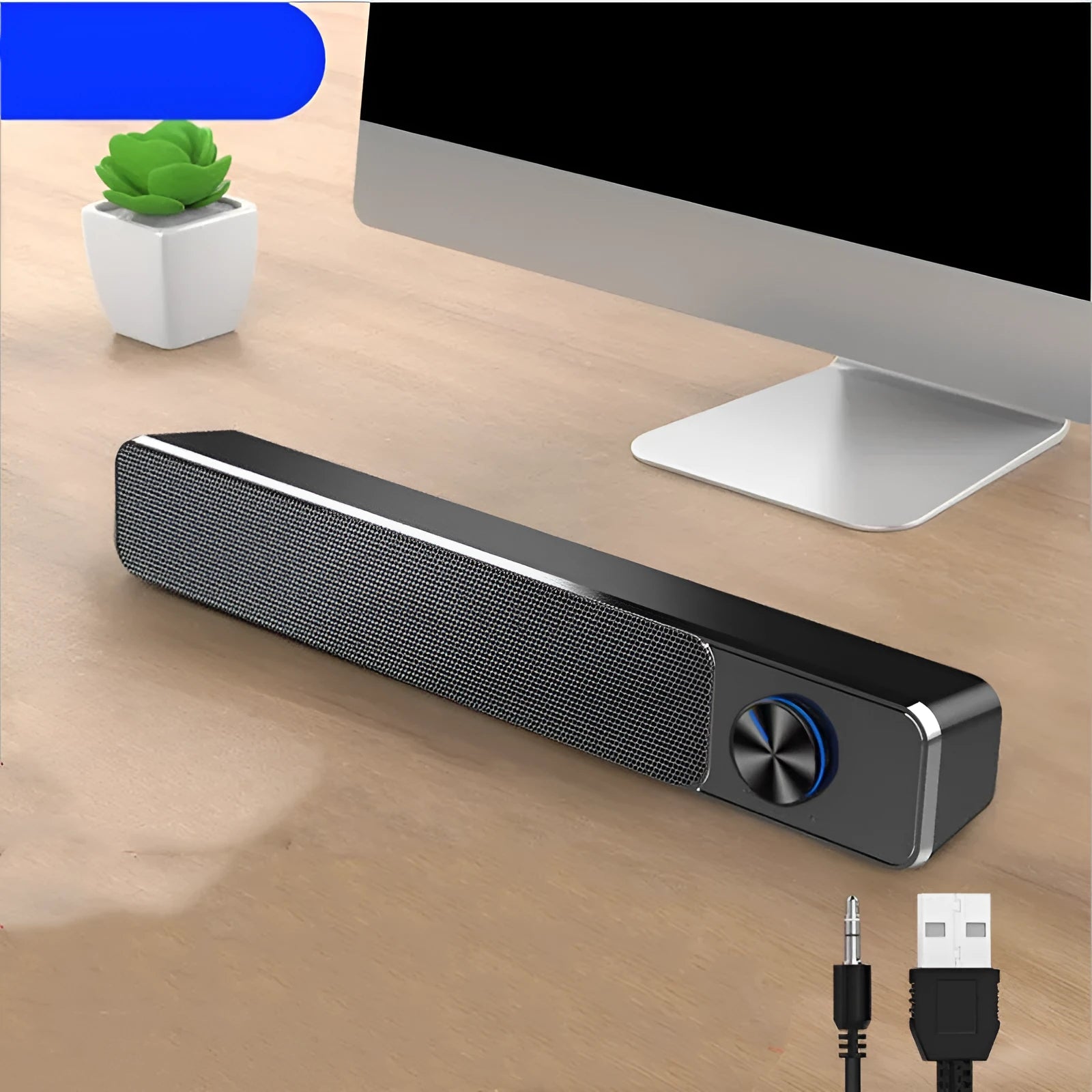 Desktop wired computer speaker with USB cable connected, black ABS PC shell, placed beside computer monitor