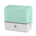 Pink and white double-layer pluggable heated lunch box with stainless steel interior and push-button controls.