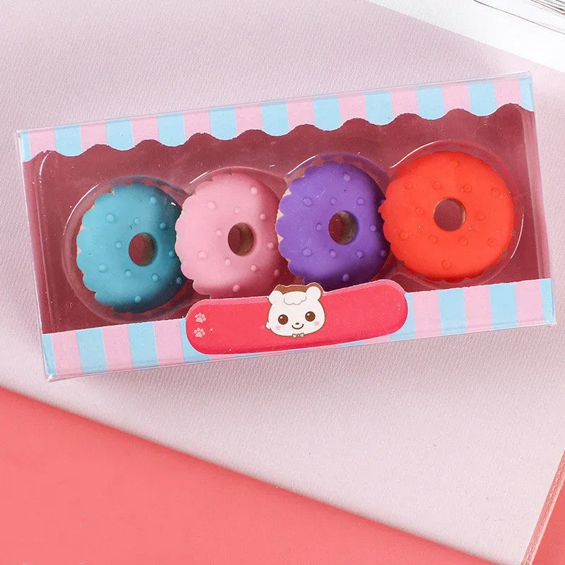 Set of twelve colourful cartoon food-shaped erasers including ice creams, doughnuts, and lollipops.