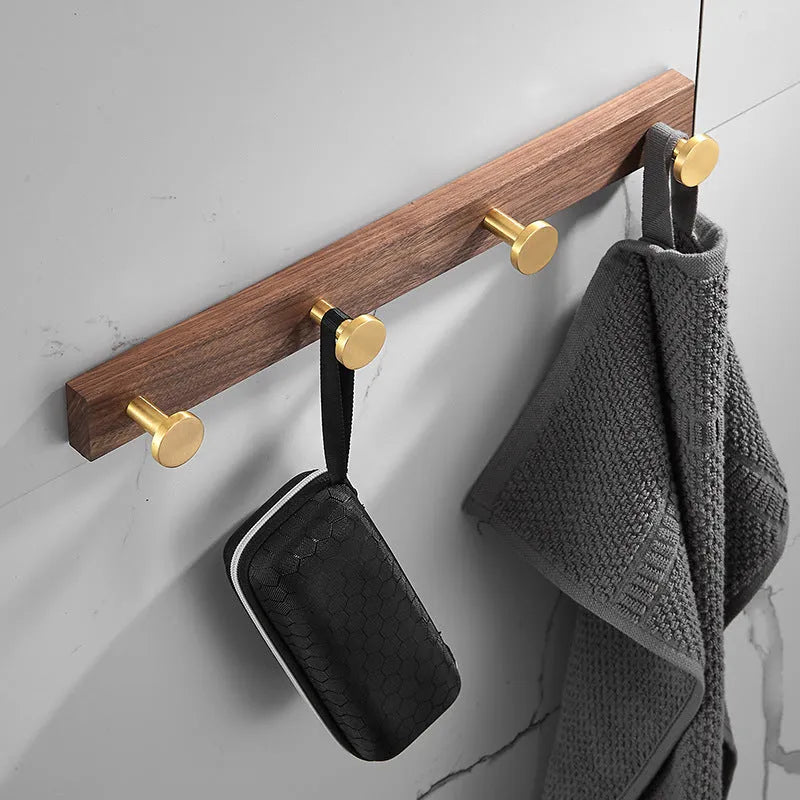 Black walnut aluminium bathroom hook rail with brass finish and multiple hooks for towel storage