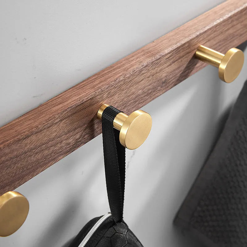 Black walnut aluminium bathroom hook rail with brass finish and multiple hooks for towel storage