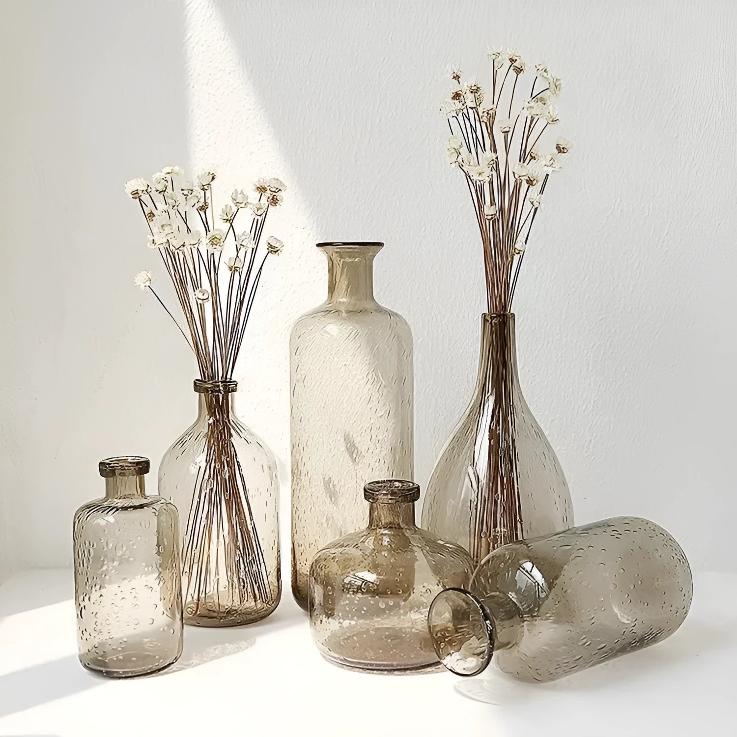 Geometric grey bubble glass vase with a textured surface on a plain background.