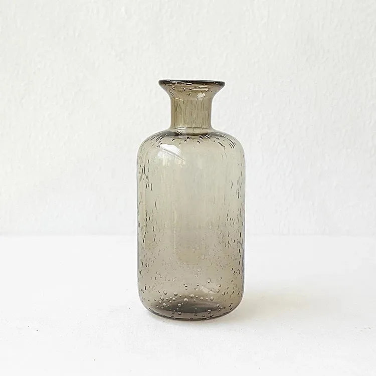 Geometric grey bubble glass vase with a textured surface on a plain background.