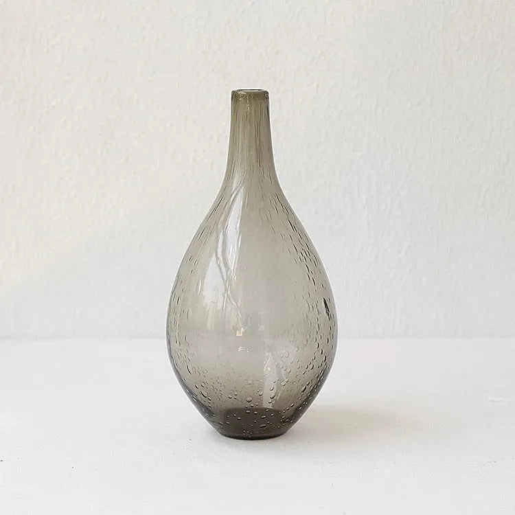 Geometric grey bubble glass vase with a textured surface on a plain background.