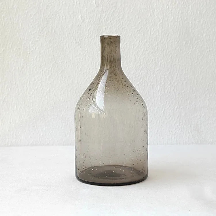 Geometric grey bubble glass vase with a textured surface on a plain background.