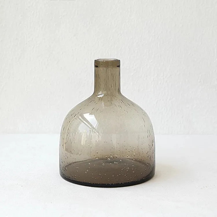 Geometric grey bubble glass vase with a textured surface on a plain background.