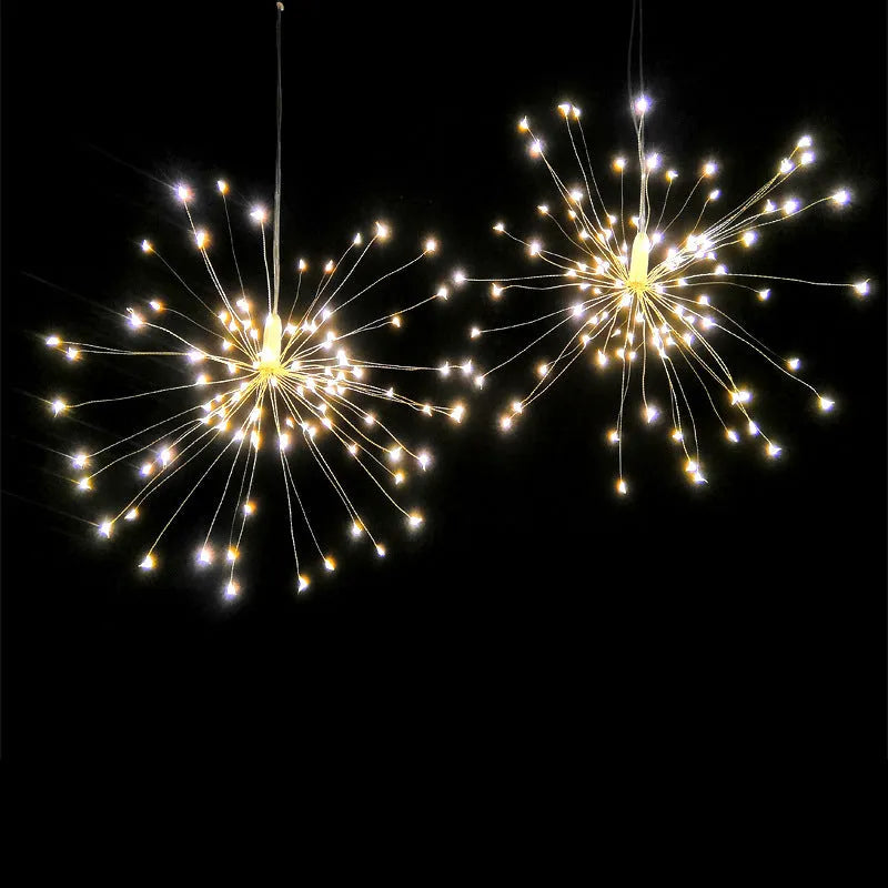 Solar-powered LED meteor shower firework light hanging outdoors with warm white lights.