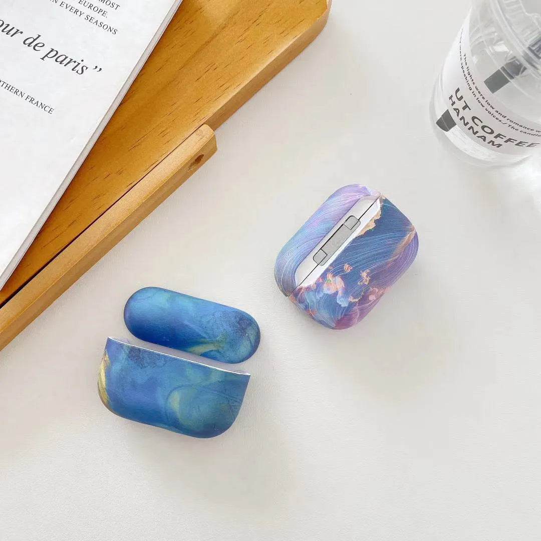 Hard plastic protective sleeve for Apple AirPods in pink and blue watercolour designs