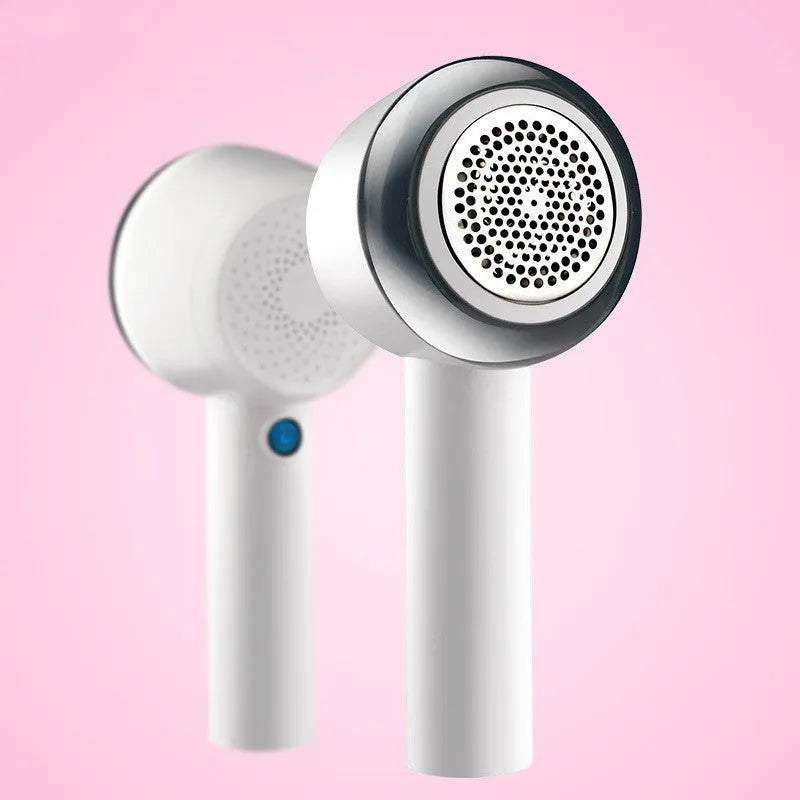 White rechargeable clothes shaver and beater on a plain background.