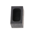 A square graphite crucible or melting pot for gold, silver, and precious metals on a workbench.