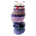 Hand carved purple fluorite owl ornament on a neutral background, showing detailed carving and natural crystal colour.