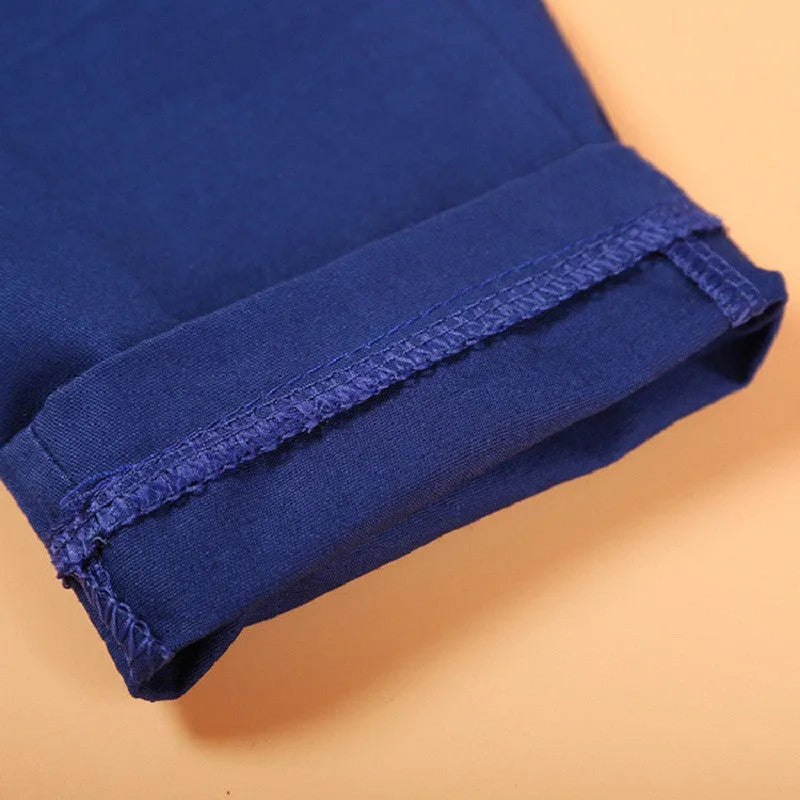 Blue boys' suit set on a hanger featuring a vest, turtleneck, trousers, and tie for toddlers.