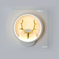 Nordic deer antler shaped wall lamp with remote control on a white wall.