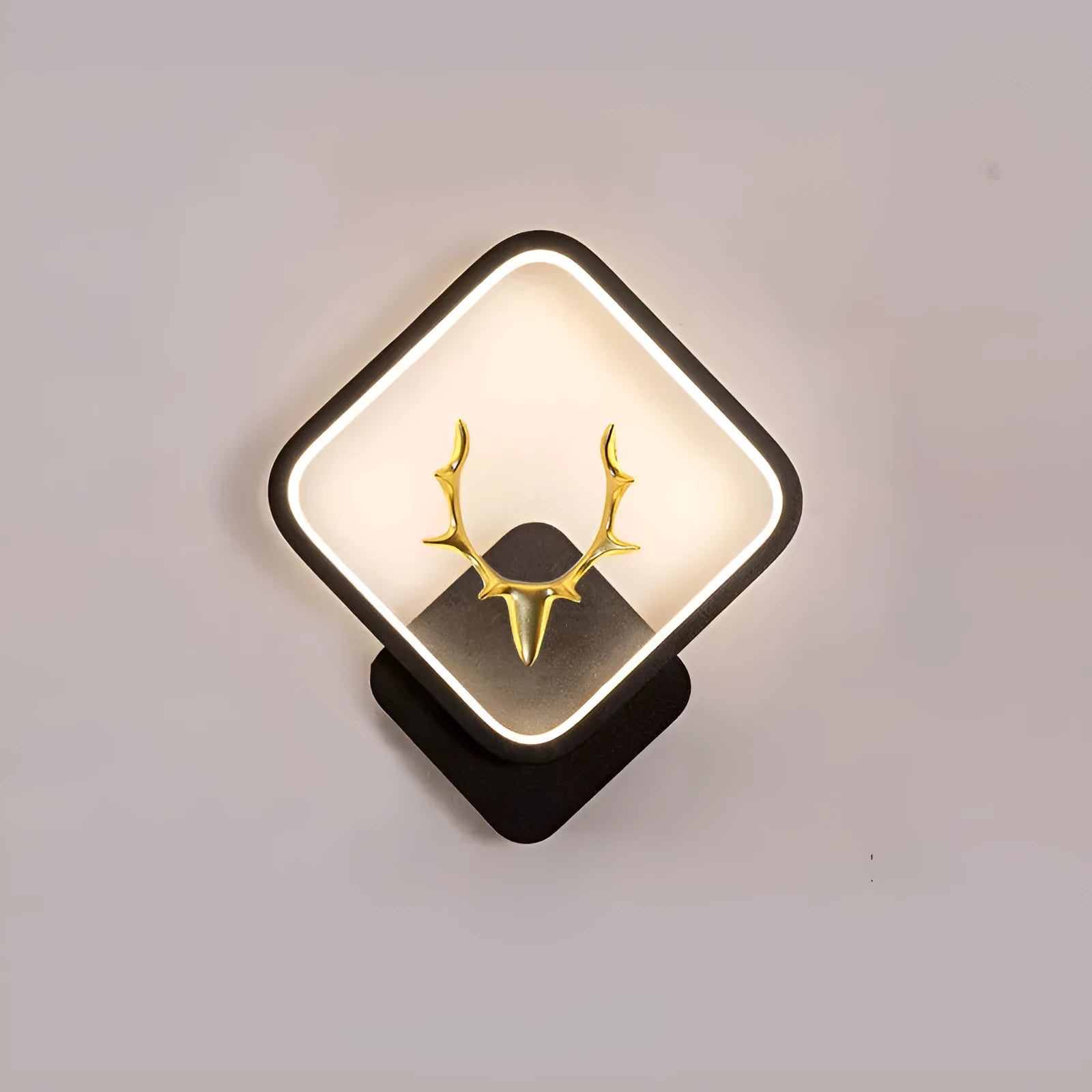 Nordic deer antler shaped wall lamp with remote control on a white wall.