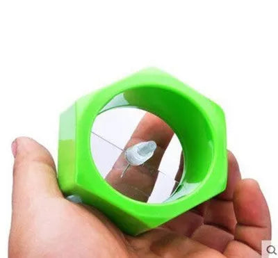 Yellow and green plastic spiral vegetable cutter for slicing cucumbers.