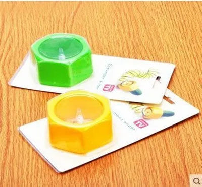 Yellow and green plastic spiral vegetable cutter for slicing cucumbers.