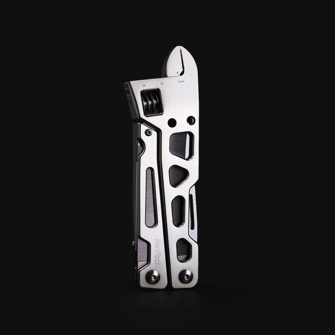 White stainless steel multi-function tool showing integrated wrench, knife blade, and needle nose pliers.