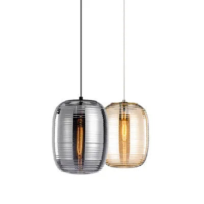 Simple modern glass table lamp in cognac colour on a wooden table.