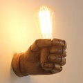 Resin fist-shaped wall lamp in black, white, or wood grain finish for left or right hand mounting.