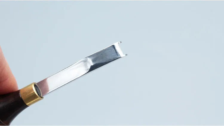 Leather hand tool for barbers with wide shovel edge thinning knife and drum shovel.