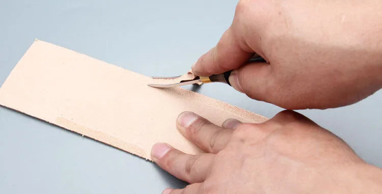 Leather hand tool for barbers with wide shovel edge thinning knife and drum shovel.