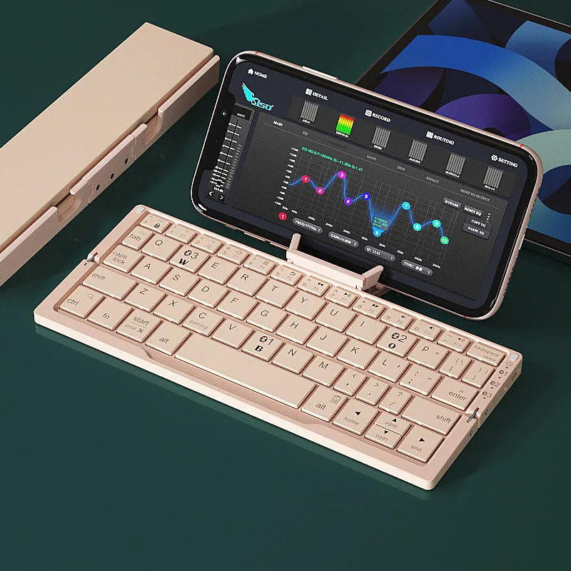 Silver white folding Bluetooth keyboard with built-in stand holding a tablet
