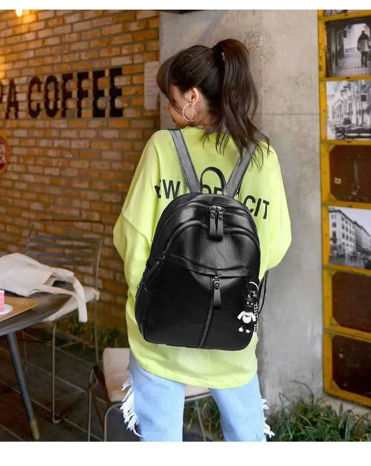 Black PU leather backpack with soft surface showing ID compartment and double luggage straps