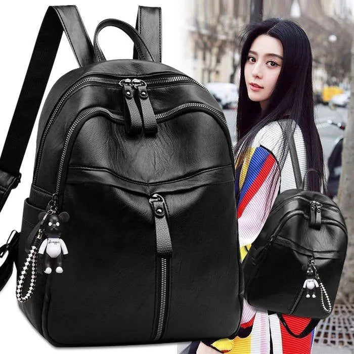 Black PU leather backpack with soft surface showing ID compartment and double luggage straps