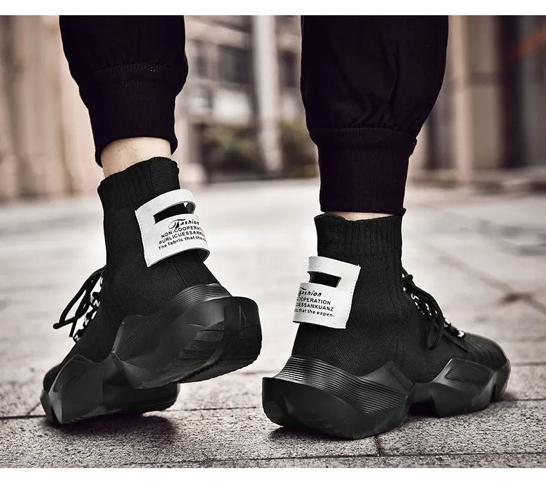 Men's black and white sports-style casual shoes with mesh lining, shown in large sizes.