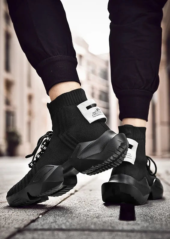 Men's black and white sports-style casual shoes with mesh lining, shown in large sizes.
