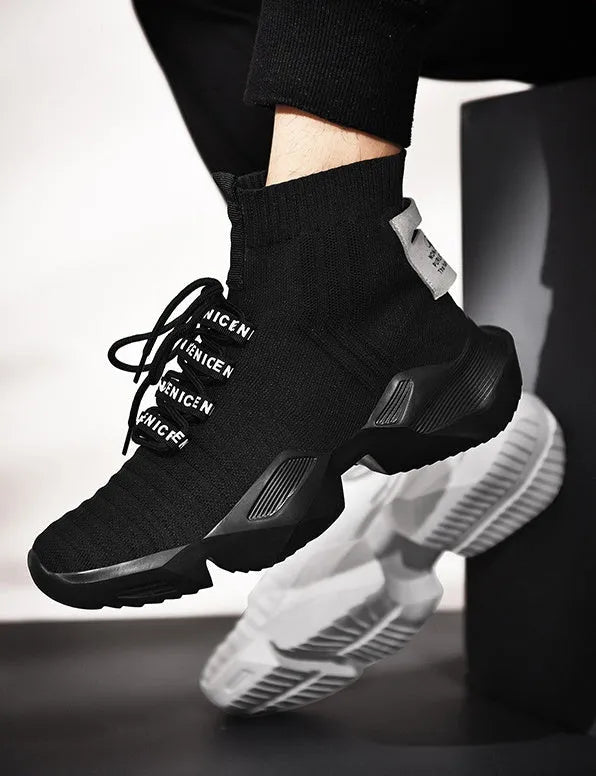 Men's black and white sports-style casual shoes with mesh lining, shown in large sizes.