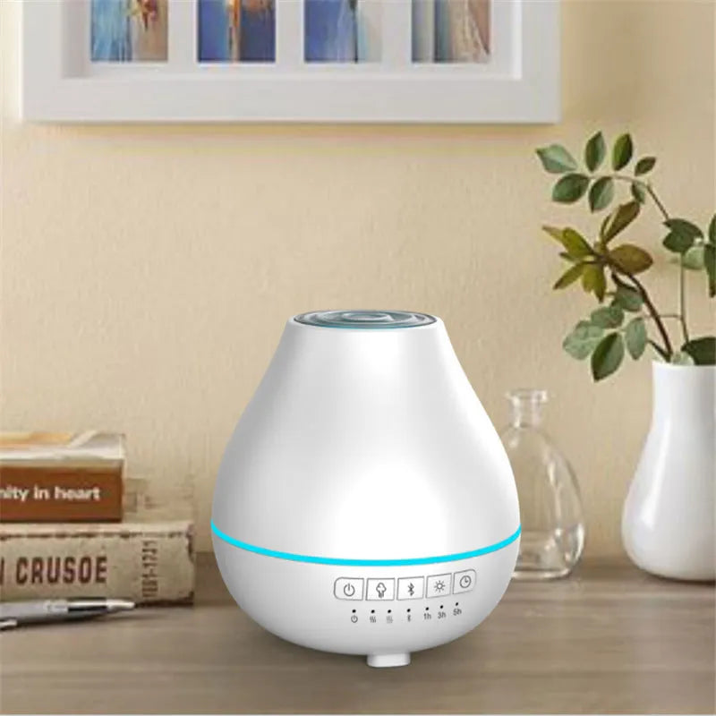 White circular Bluetooth humidifier and aroma diffuser with night light on a table.