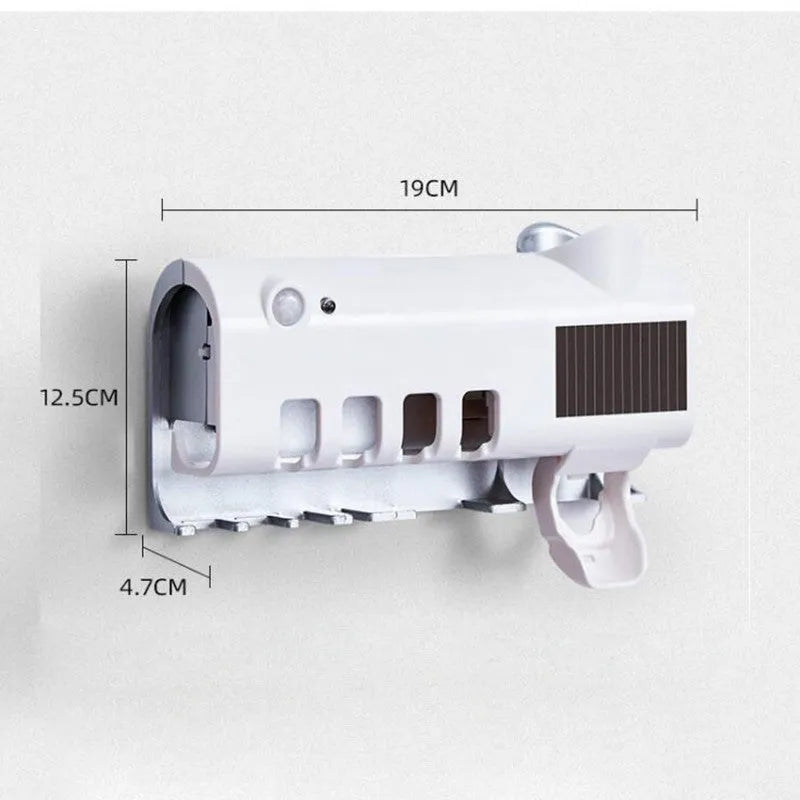 White automatic toothpaste squeezer and toothbrush steriliser unit mounted on bathroom wall