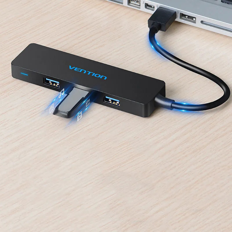Black USB 3.0 hub with four ports, short attached cable, and nickel-plated connectors.