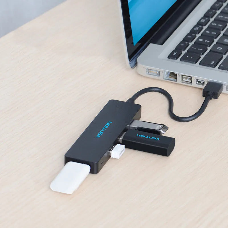 Black USB 3.0 hub with four ports, short attached cable, and nickel-plated connectors.