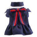Pet dog or cat wearing a navy blue British-style woolen cloth skirt costume on a neutral background