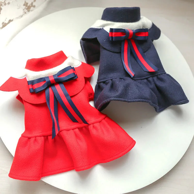 Pet dog or cat wearing a navy blue British-style woolen cloth skirt costume on a neutral background