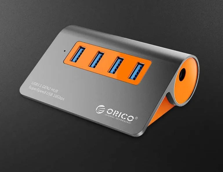 Dark grey and orange aluminium USB 3.1 hub with four ports and individual power switches