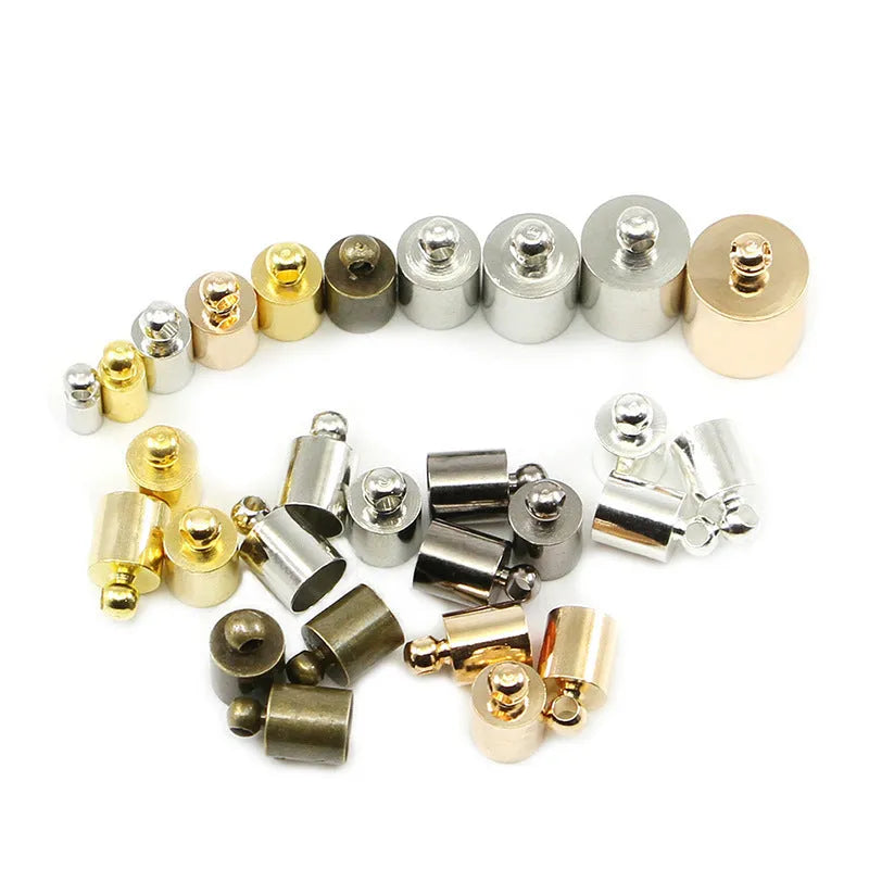 Assortment of multi-colour copper caps in gold, silver, black, and bronze finishes for jewellery making.