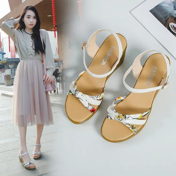 Pink women's wedge sandals with a thick heel, fish mouth design, and a silver buckle.