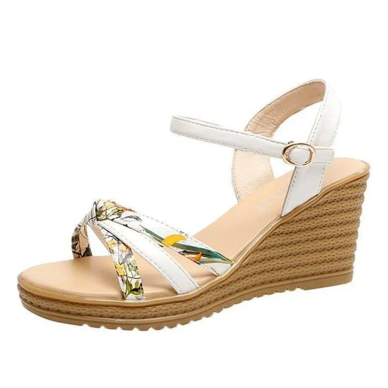 Pink women's wedge sandals with a thick heel, fish mouth design, and a silver buckle.