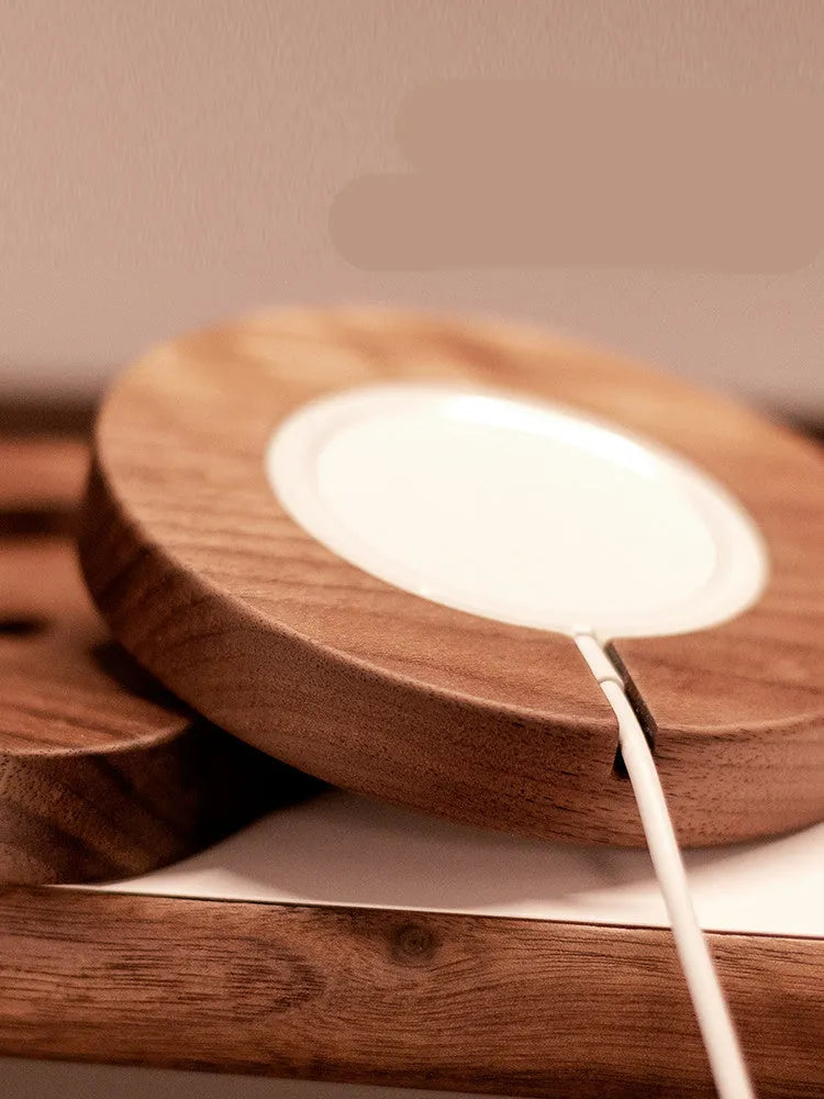 Walnut wood magnetic wireless charger for iPhone with MagSafe compatibility on desk