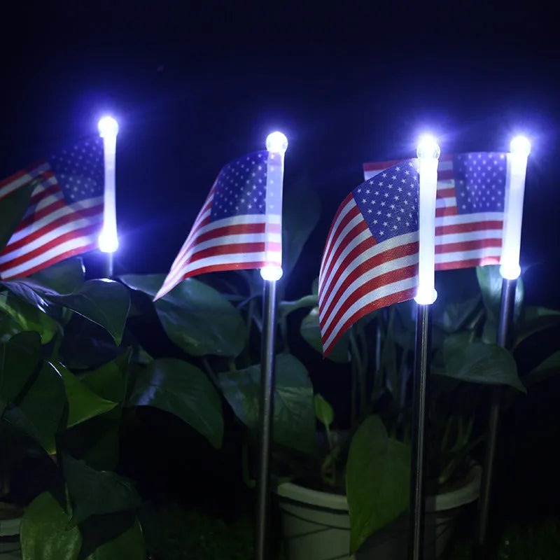 Solar garden flag light with stainless steel pole showing American flag design illuminated by LED