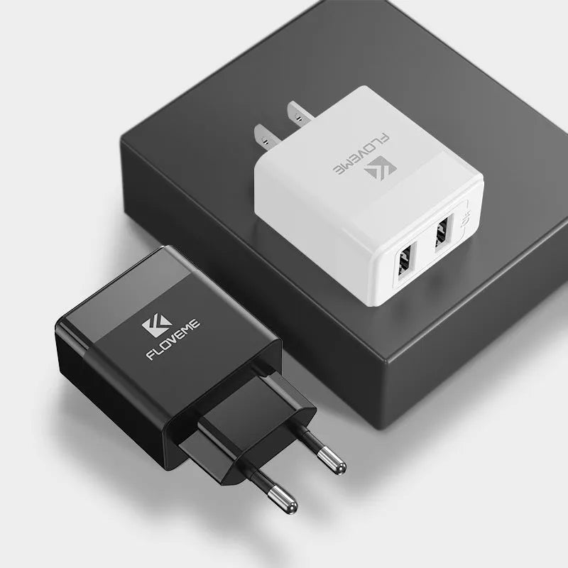 Black and white travel charger with US and European plugs showing USB port for 5V 2.1A mobile phone charging