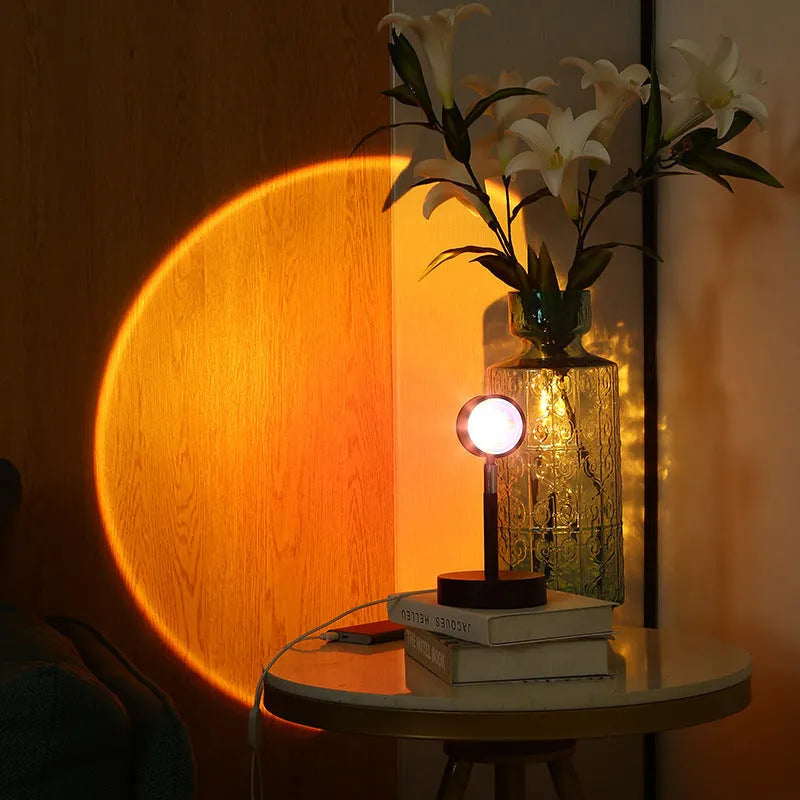 Black USB dual-head sunset rainbow projection lamp with touch controls on table